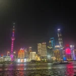 Night view of Shanghai&rsquo;s Lujiazui skyline with the Oriental Pearl Tower and city lights reflecting on the river.