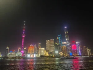 Night view of Shanghai&rsquo;s Lujiazui skyline with the Oriental Pearl Tower and city lights reflecting on the river.