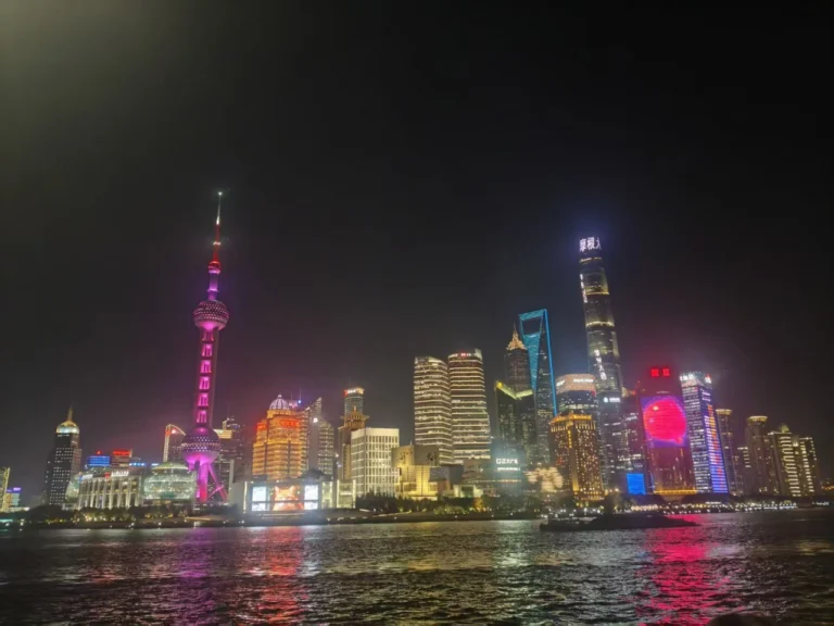 Night view of Shanghai&rsquo;s Lujiazui skyline with the Oriental Pearl Tower and city lights reflecting on the river.